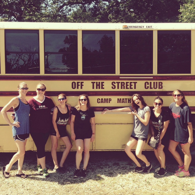 KSM employees posing outside of a school bus.