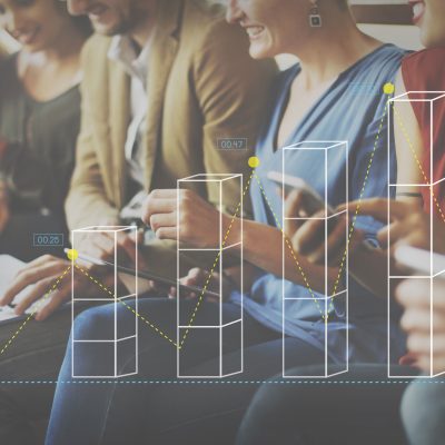 Image of people sitting on a bench looking at phone and computer screens.