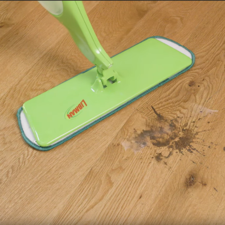 Libman mop cleaning up spill on hardwood floor