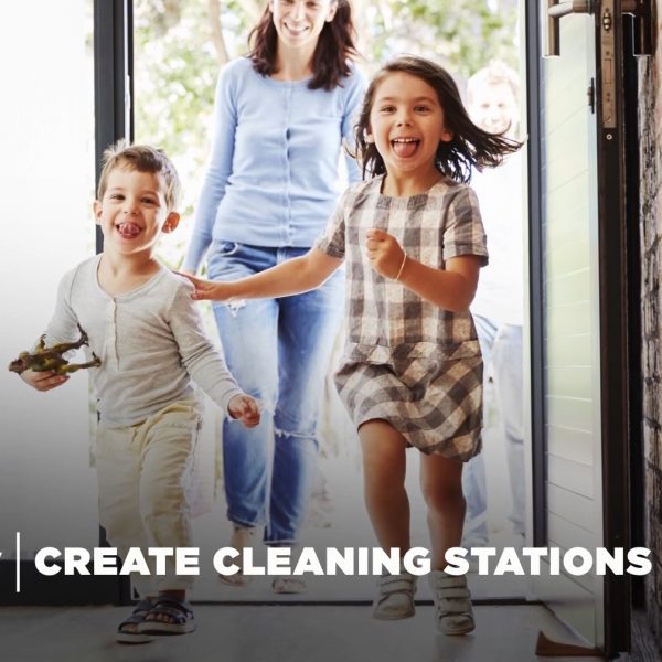 Image of a woman and two children entering a home.